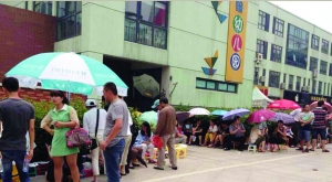金壇市實(shí)驗(yàn)幼兒園門前，家長在排隊(duì)
