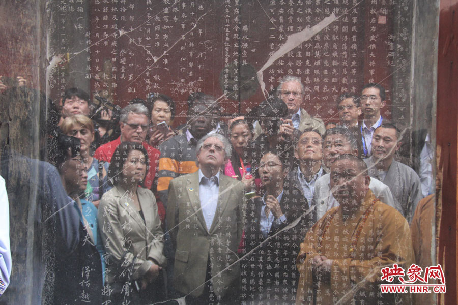 在一塊石碑前，少林寺方丈正在講解