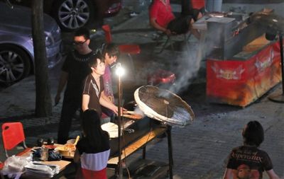7月4日，青年路國美第一城小區(qū)附近的夜市臨街露天燒烤攤。