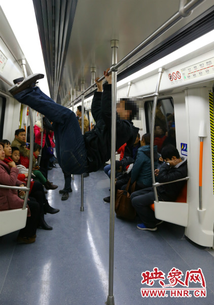 地鐵試乘日，一男子在車廂內攀爬扶手自娛自樂
