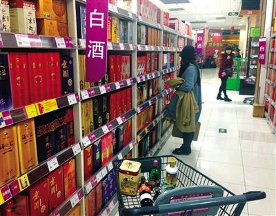 顧客在商場的高檔白酒貨架前駐足挑選。春節(jié)臨近，受“禁令”影響，以高檔白酒為代表的節(jié)日禮品市場面臨考驗。記者 王遠征 攝