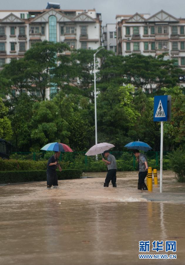 5月11日，人們在深圳西麗涉水行走。