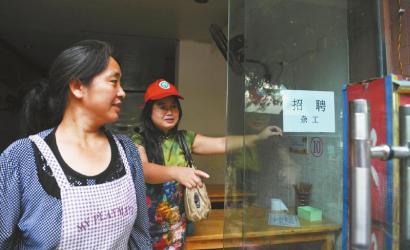 8月14日，市民志愿者體驗城管執(zhí)法招呼商家不要亂張貼。