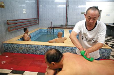 客人在搓澡。近日，百年歷史的鑫園浴池宣布將關(guān)張。新京報(bào)記者