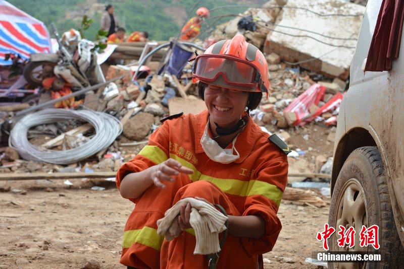 2014年8月5日，女兵在云南魯?shù)辇堫^山鎮(zhèn)廢墟中搜救被困者。