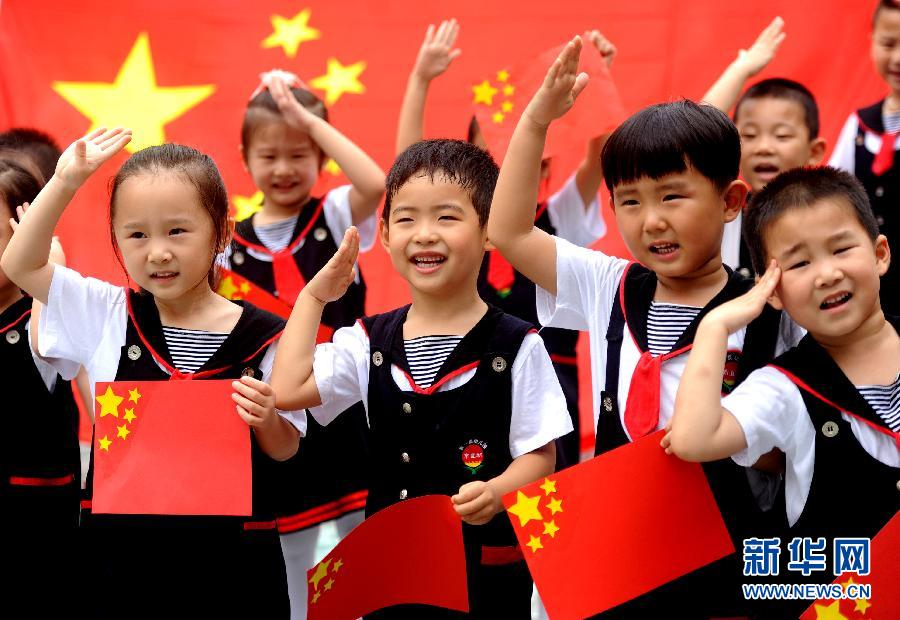  9月28日，安徽淮南市直機關(guān)幼兒園的小朋友在國旗前唱《國歌》，慶祝祖國65周歲生日。