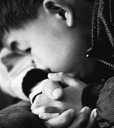 10歲小兒子緊緊握著哥哥的手。資料圖片