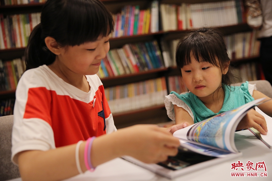 姐姐王藝茹，11歲，小學(xué)五年級學(xué)生；妹妹王有君，5歲：像喜歡看電視一樣喜歡看書。